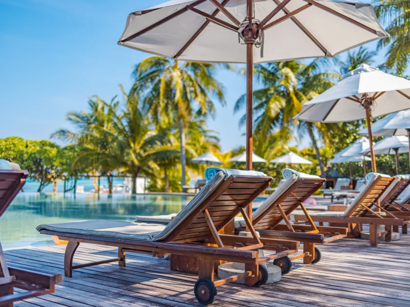 medium-vecteezy_umbrellas-and-chairs-around-outdoor-swimming-pool-in-resort_12045663_medium